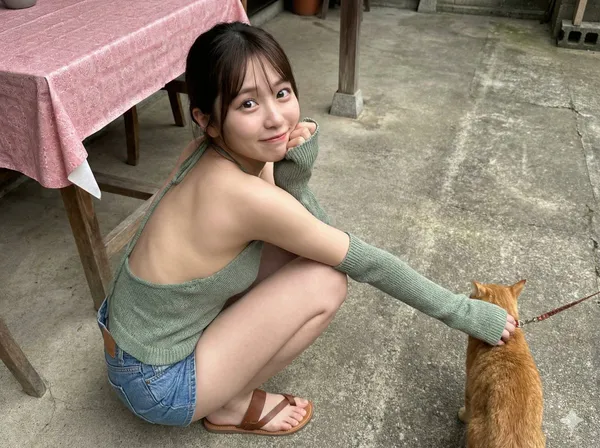 Young Asian Girl Squatting in Concrete Courtyard