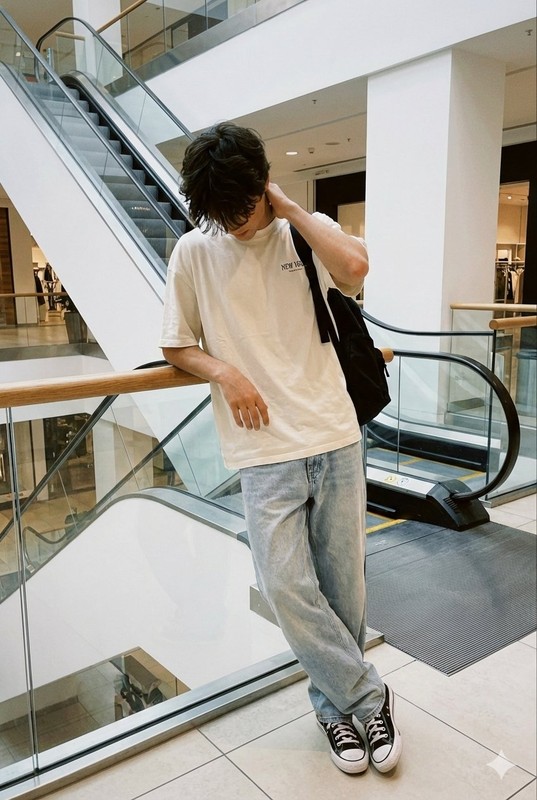 Introspective Boy by Mall Escalator