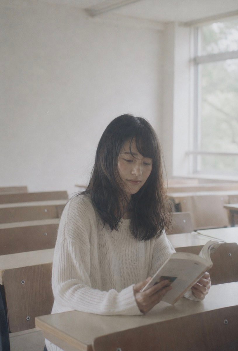 Faceless Student Reading in Classroom