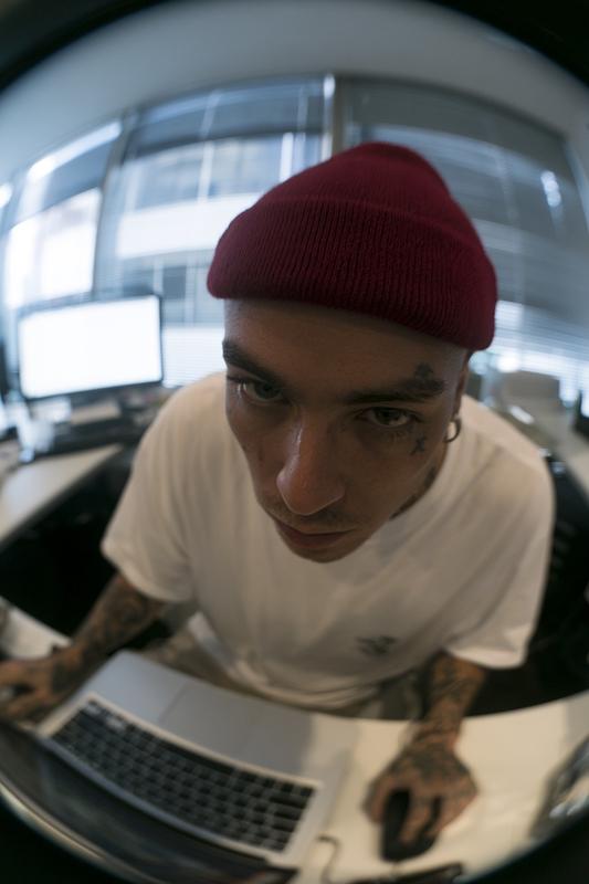 fisheye lens captures a person with a red beanie...