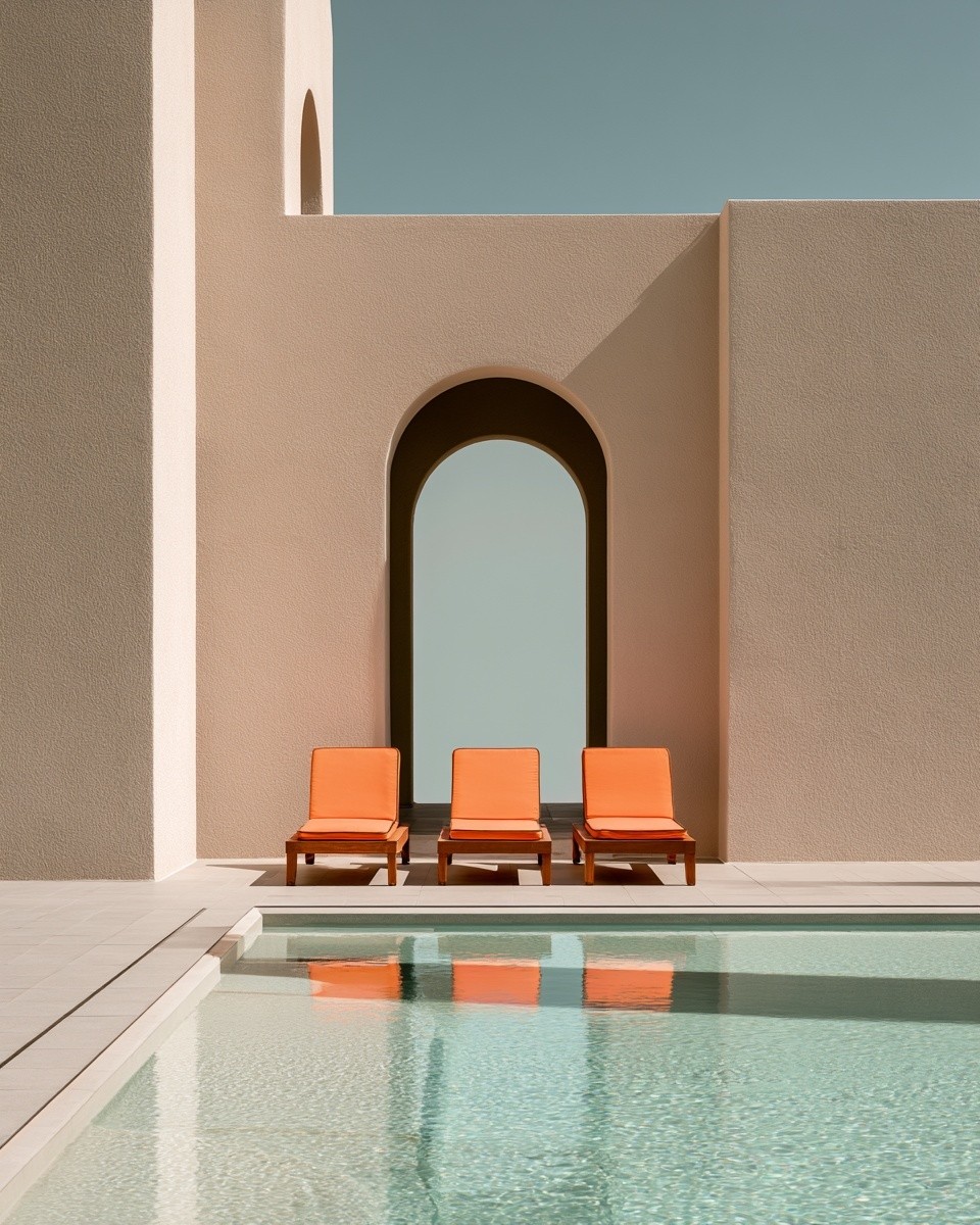 A serene luxury poolside scene with three bright orange...