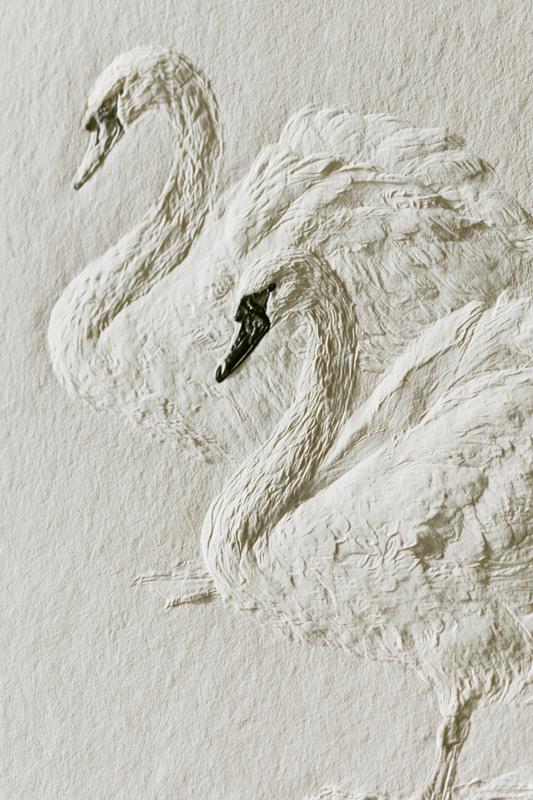 a refined design of 2 swans pressed into thick...