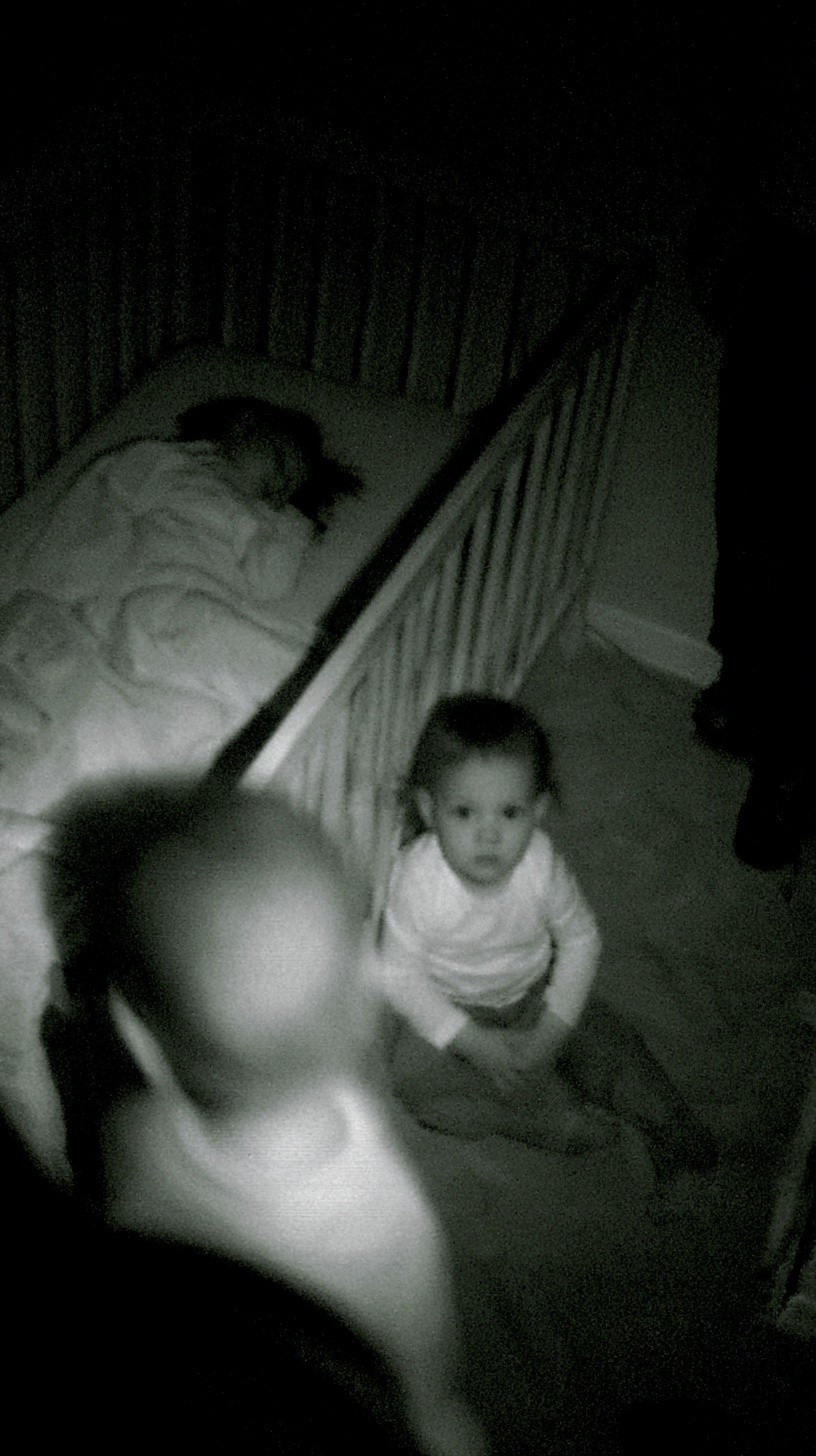 grainy monochrome baby monitor footage night vision security camera...