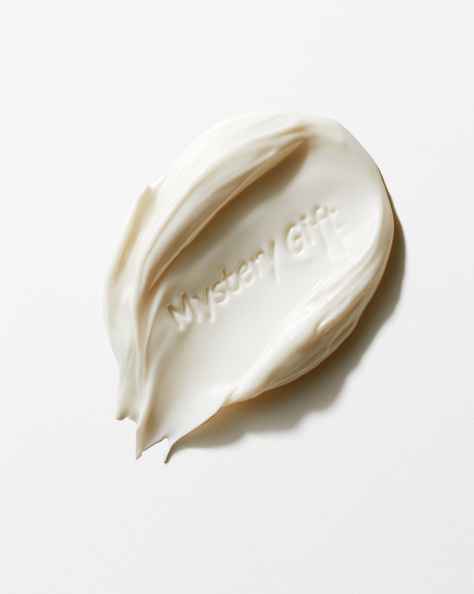 A single solid white-colored swatch of cosmetic cream on...