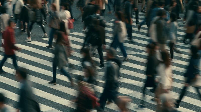 realistic live-action still of many people walking across a...