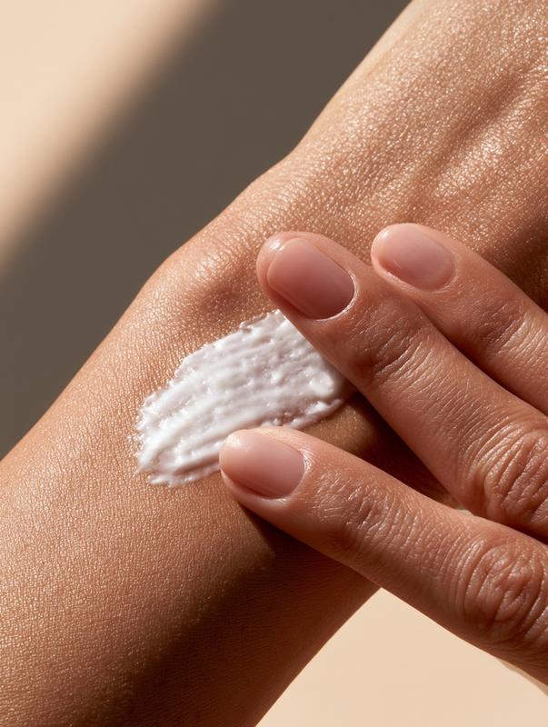 Slow realistic body cream application A woman's hand gently...