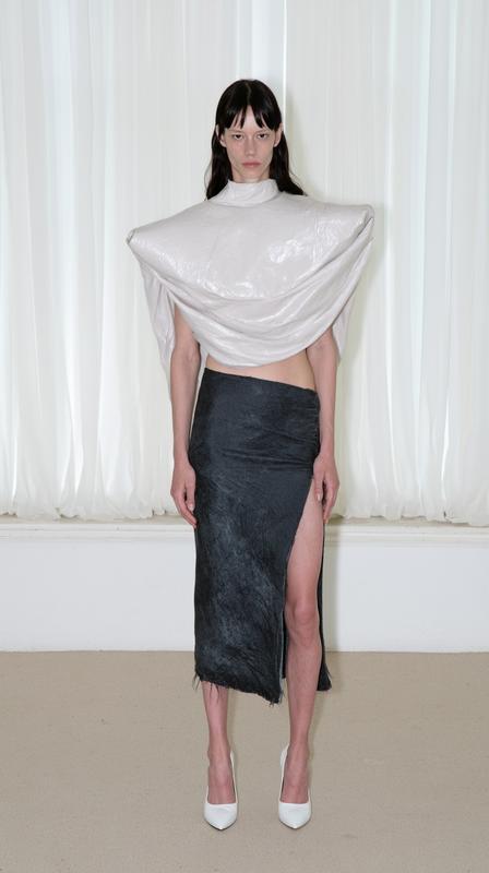 a studio scene with soft white vertical blinds and...