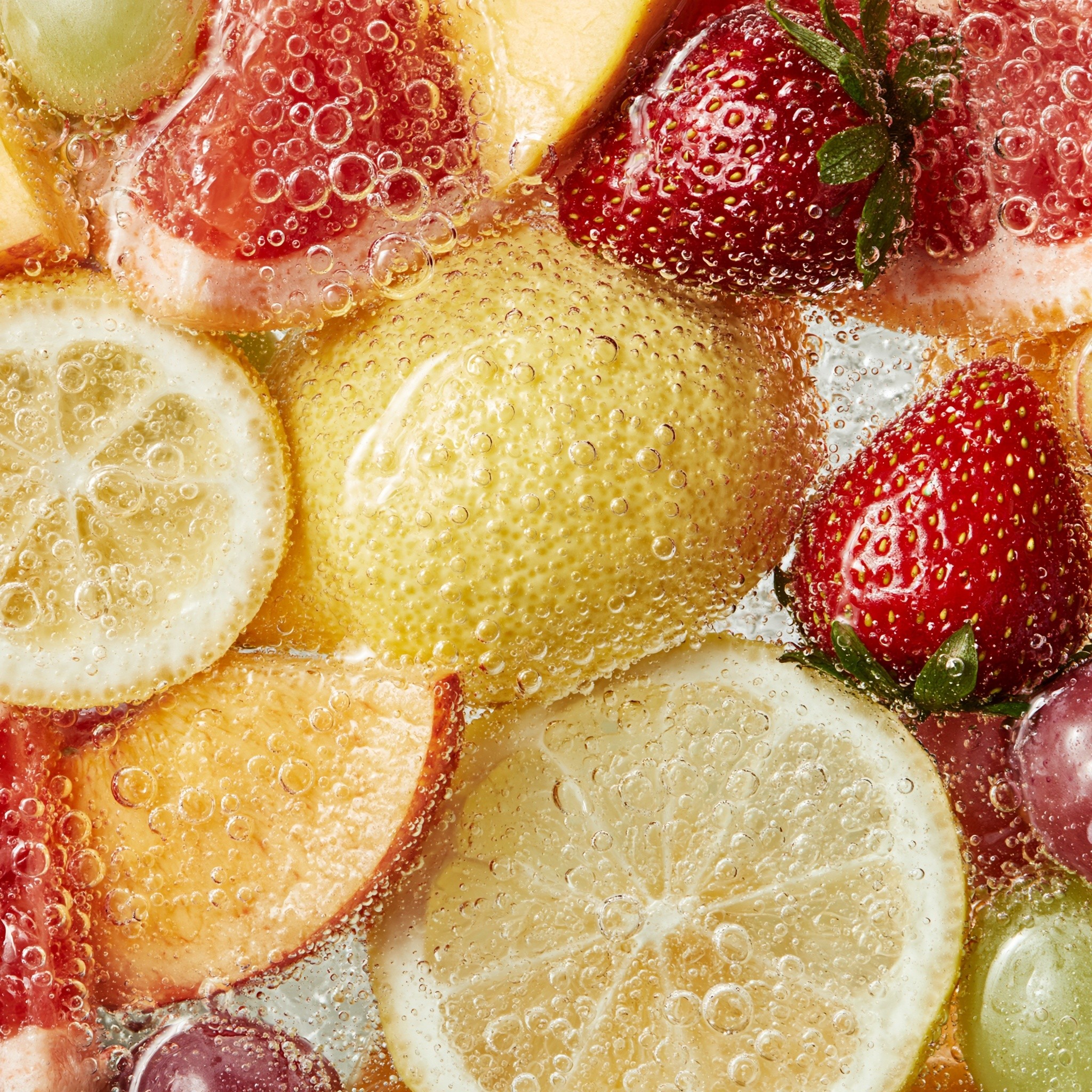 Lemon peach grapefruit strawberry grapes soaked in sparkling water...