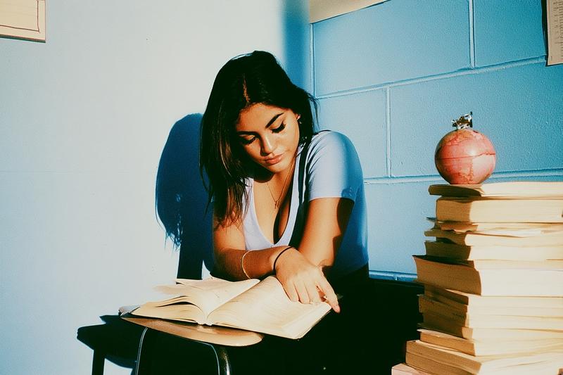 beautiful latina woman student studying exam in the classroom...