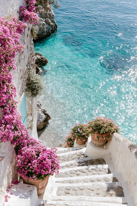 Dreamy hidden Amalfi Coast pathway descending toward a secluded...