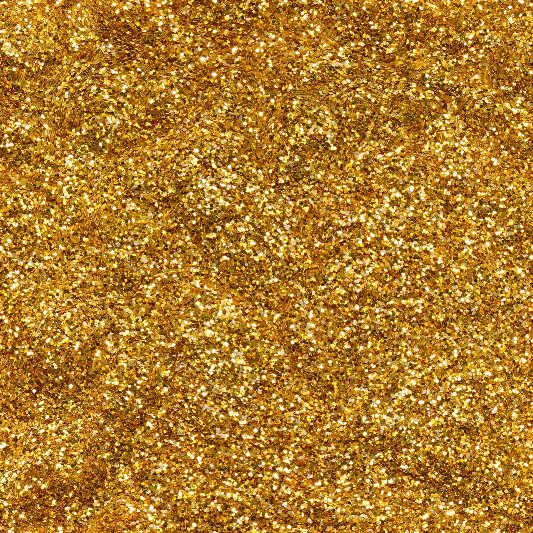 A full-frame shot of shimmering light golden sequins creating...