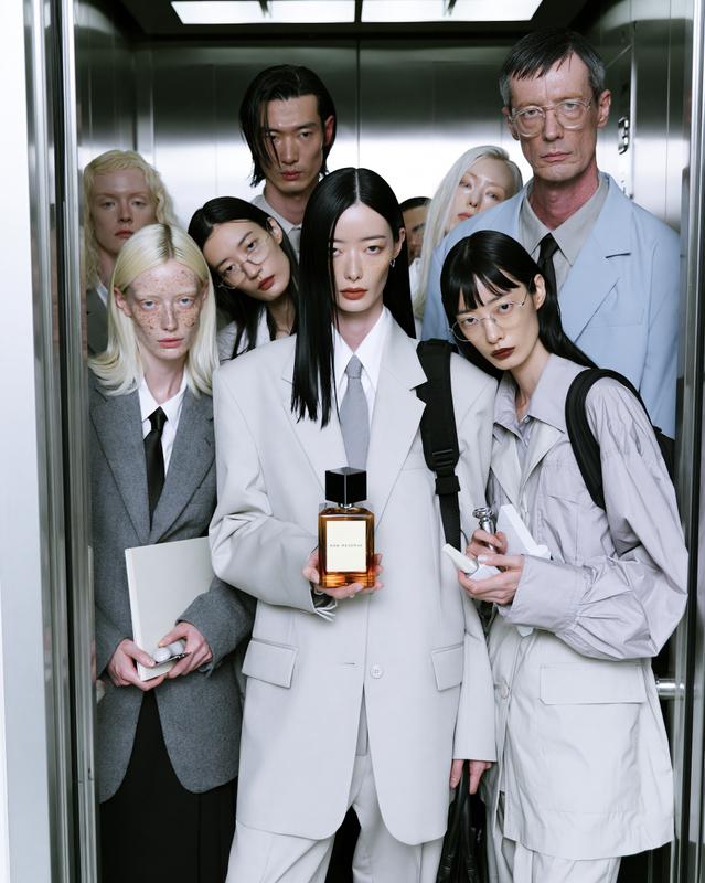 RAW RESERVE editorial fragrance scene a group of stylish...