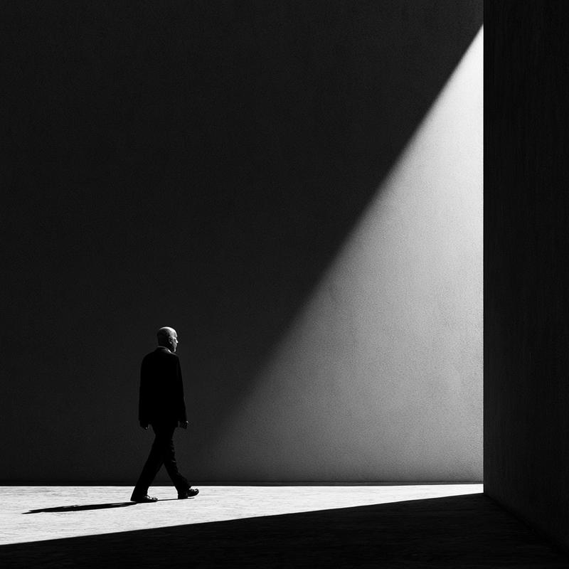 a man who wearing no hat is walking somewhere...