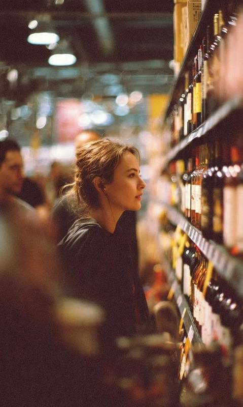 Side-Profile Moment in a Wine Aisle